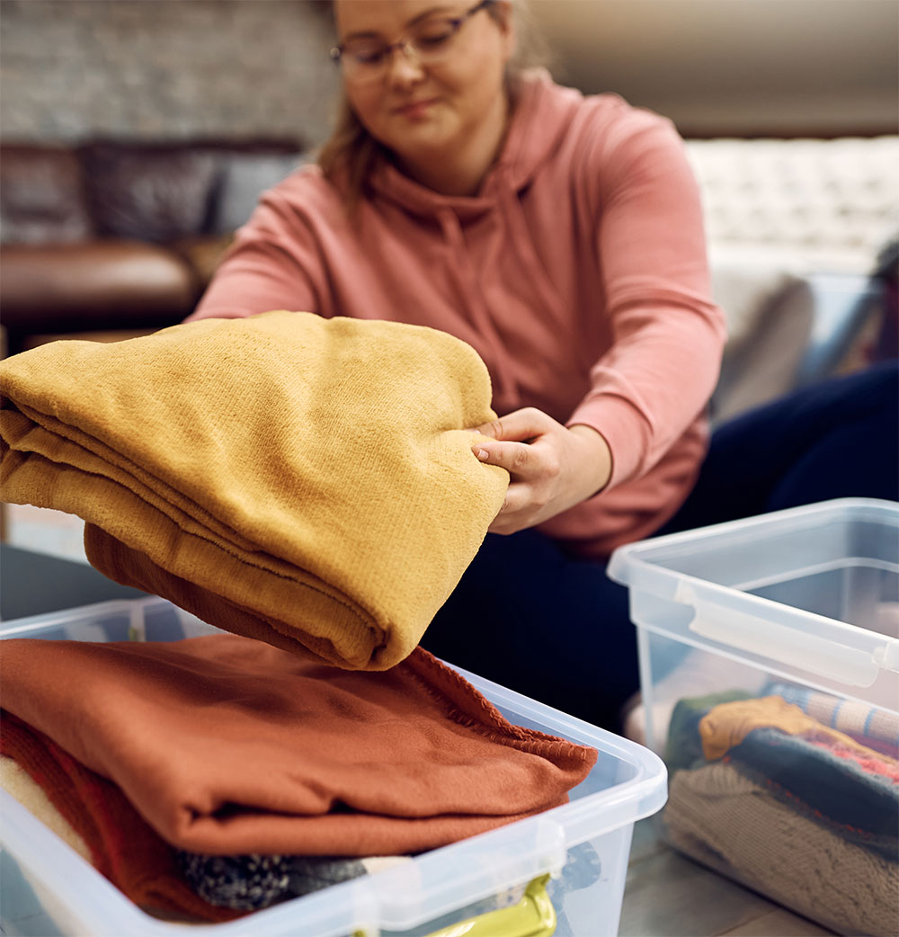 Volunteer organizing donated clothing